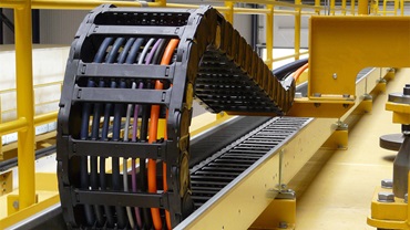 Harnessed energy chains for crane systems